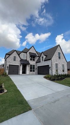 a large house with two garages on the front