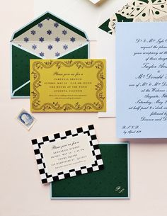 the wedding stationery is laid out on top of each other, including an envelope