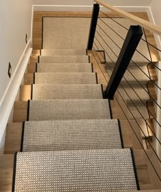 a staircase with carpeted steps and handrails