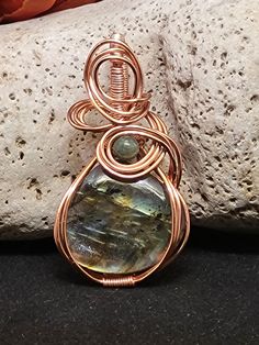 This one-of-a-kind iridescent Labradorite pendant, accented with vibrant Aventurine, is beautifully wire-wrapped to create a striking and meaningful piece.  Labradorite is renowned for its transformative healing properties, believed to aid both the body and spirit in self-healing. Its captivating play of colors symbolizes intuition and inner strength, while also providing protection against negative energies. Aventurine, known as the "Stone of Opportunity," complements Labradorite by promoting luck, prosperity, and emotional balance. Together, these stones create a powerful synergy, enhancing your spiritual growth and overall well-being.  This unique pendant not only adds a stunning touch to any outfit but also serves as a reminder to embrace healing and harness your true potential. Wear i Unique Pendant, Self Healing, Spiritual Growth, Natural Crystals, Semiprecious Stones, Wire Wrapped