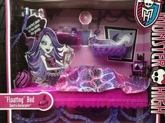 a pink and purple doll bed in a box with accessories on it's sides