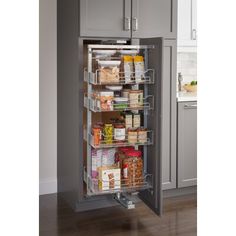 an organized pantry in a kitchen with stainless steel cabinet doors and shelves filled with food