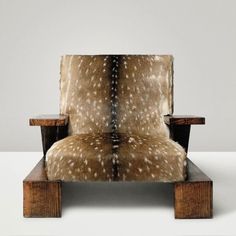 an animal print chair sitting on top of a wooden table