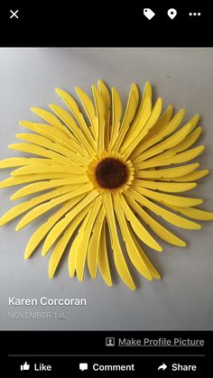 a yellow flower that is sitting on top of a white surface with the words make profile pictures like comments