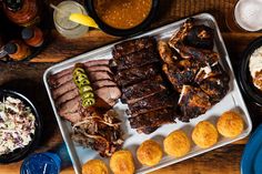 a table topped with lots of different types of meats and other foods on top of it