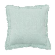 a light green pillow with fringes on the front and back of it, against a white background