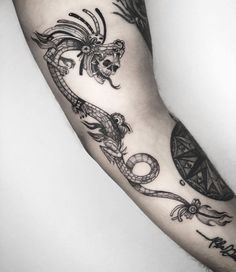 a man's arm with some tattoos on it