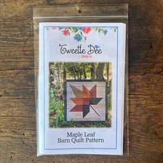 the maple leaf barn quilt pattern is packaged in a plastic package on a wooden table