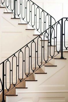 a set of stairs with wrought iron railings