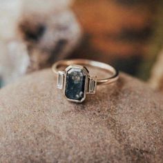 a close up of a ring on top of a rock