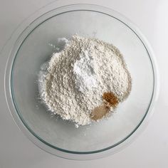 a glass bowl filled with flour and sugar