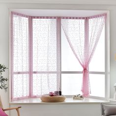 a pink curtained window with polka dots on it in a white living room setting