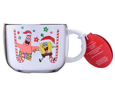 a white coffee mug with an image of spongebob and santa clause on it