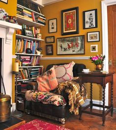 a living room filled with furniture and pictures on the wall