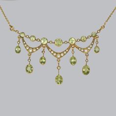 Stunning peridot & seed pearl necklace by Birks This rare Edwardian necklace is by the famous Canadian jewellers Birks Beautifully designed and hand crafted in 14 ct gold this fringe necklace is set with alternating peridots and seed pearls, with seed pearl swags below and suspending further seed pearl and oval peridots. The assembler hangs from an integral trace link chain with spring clasp The reverse is signed BIRKS 14ct. It dates to around 1910 This elegant pendant looks fabulous when worn T Gold Peridot Necklaces For Wedding, Pearl Jewelery, Edwardian Necklace, Edwardian Jewelry, Big Diamond, Fringe Necklace, Elegant Pendant, Jewel Box, Seed Pearl