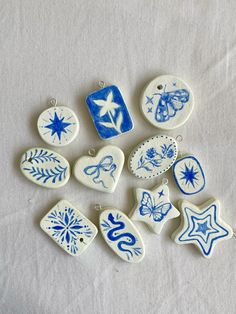 several ceramic ornaments are shown on a white surface, including one with blue and white designs