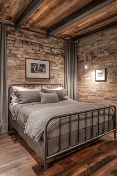 a bed sitting in a bedroom next to a brick wall and wooden floored walls