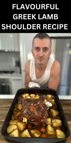 a man sitting in front of a roasting pan filled with meat and potatoes on top of