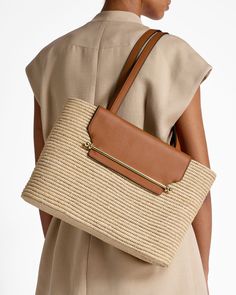 Our holiday favourite Strathberry Basket - an ethically-crafted statement piece designed for your summer wardrobe is now available in a larger size. Reminiscent of sunny days spent in leisure, this woven raffia bag was handcrafted by women in Morocco, providing them with an additional income and a flexible working schedule. Featuring our signature music bar, tan leather handles and a leather interior compartment with zip, keep all your summer holiday essentials handy and help support local artisans.Please note - As this basket is handcrafted, sizes may vary slightly from those shown, making every purchase unique. Summer Holiday Essentials, Music Bar, Additional Income, Holiday Essentials, Woven Raffia, Flexible Working, Raffia Bag, Natural Tan, Basket Bag