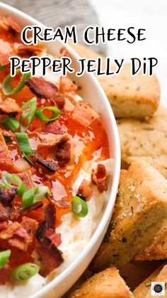 a bowl of cream cheese pepper jelly dip with crackers and bacon on the side