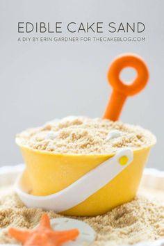 a yellow bowl filled with sand next to an orange plastic fork and starfish on top