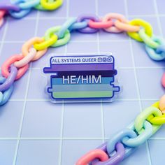 a plastic chain with an all systems outer logo on it and the words he / nim written below