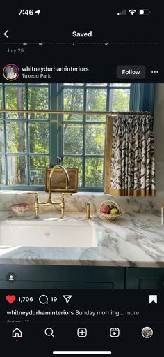 a kitchen with marble counter tops and gold faucets on the windowsills