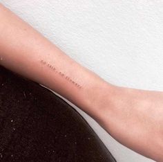 a woman's arm with a small tattoo on the left side of her arm