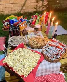 a picnic table with snacks and candles on it