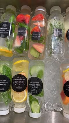 several plastic containers filled with different types of fruits and veggies in ice cubes