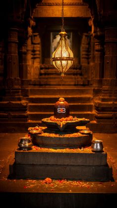 an intricately decorated fountain in front of a chandelier with lights hanging from it