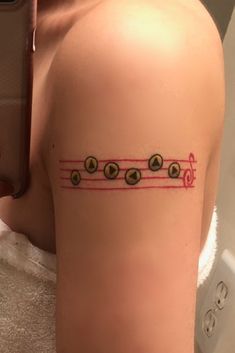 a woman with a music note tattoo on her arm