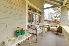 a porch with chairs and tables on it