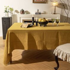 a yellow table cloth on a dining room table