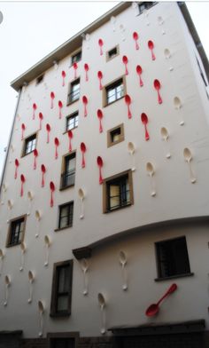 a tall building with red and white decorations on it's side