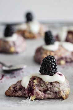 blackberry shortcakes with white icing and blackberries on top are ready to be eaten