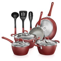 an assortment of red pots and pans with utensils in them on a white background