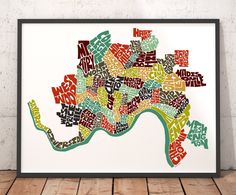 a framed map of the city of london in multicolored letters on white paper