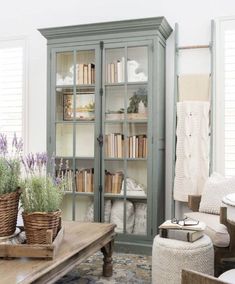 a living room filled with furniture and bookshelves next to a table in front of a window