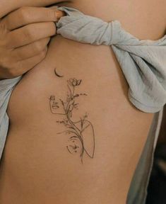 a woman's stomach with a flower tattoo on it