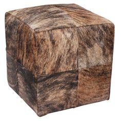 a brown and black animal print cube shaped poufce on an isolated white background