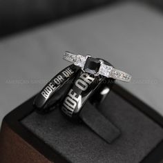 two wedding rings sitting on top of each other in a display case with the words ride or die printed on them