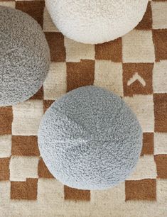 three different colored balls sitting on top of a rug