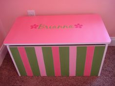 a pink and green toy box with the name aria on it