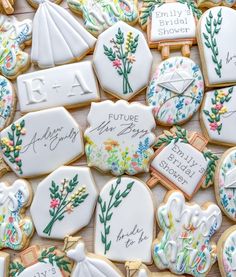 decorated cookies with the names and date of their wedding day are displayed on a table