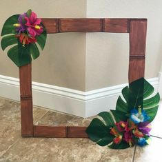 a wooden frame decorated with flowers and leaves