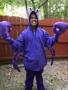 a young boy dressed as a purple crab costume