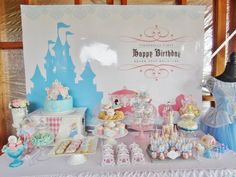 there is a birthday party set up at the table with princess cakes and cupcakes