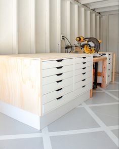 a workbench with many drawers and tools on it