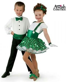 two children in green and white irish dance costumes